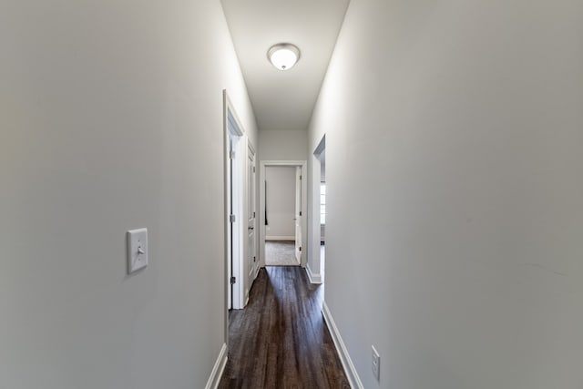 corridor with dark hardwood / wood-style flooring