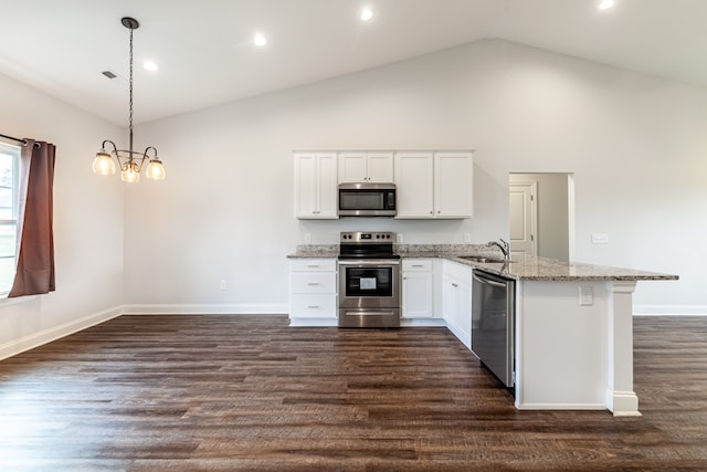 kitchen featuring stainless steel appliances, dark wood-type flooring, white cabinets, light stone countertops, and decorative light fixtures