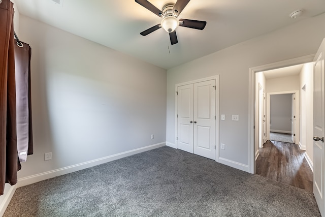 unfurnished bedroom featuring a closet, ceiling fan, and dark carpet