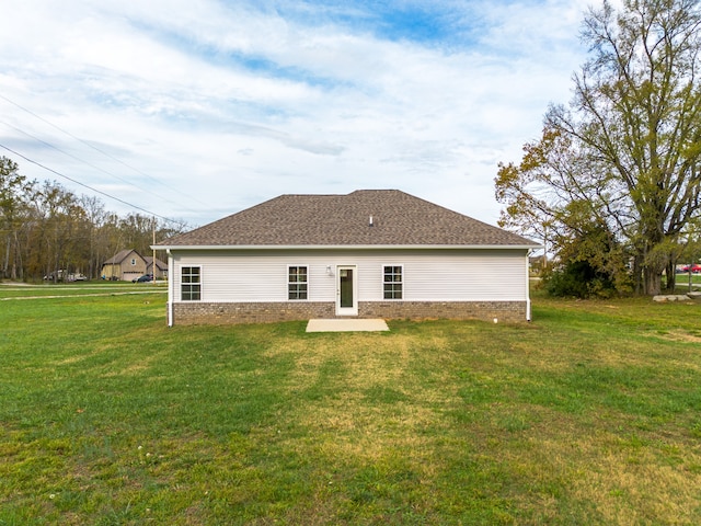 rear view of property with a lawn and a patio area