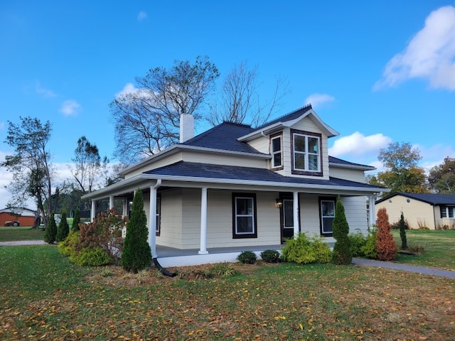 view of front facade with a porch and a front lawn