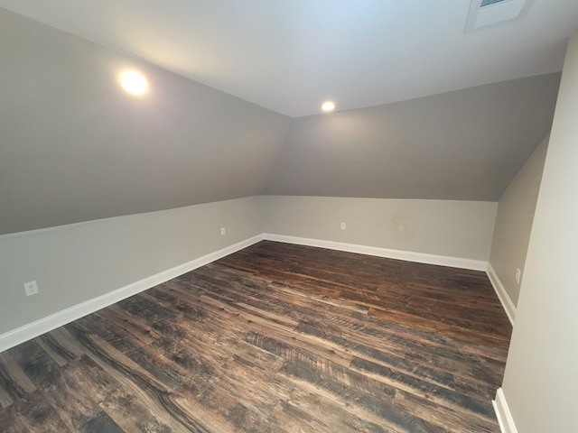 additional living space featuring dark hardwood / wood-style floors and vaulted ceiling