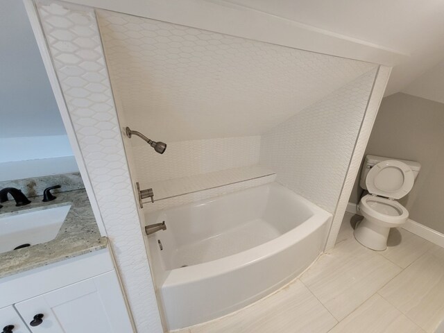 bathroom featuring toilet, a tub to relax in, vanity, and tile patterned flooring