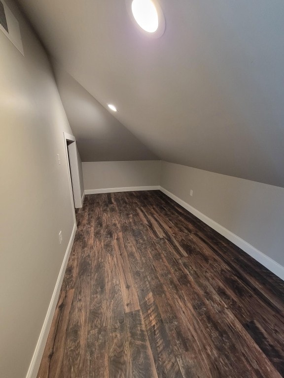 bonus room with dark hardwood / wood-style flooring and lofted ceiling