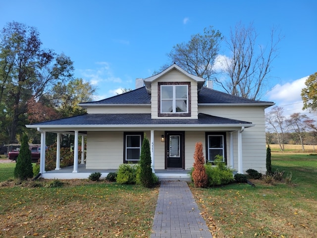 view of front of home with a porch and a front yard