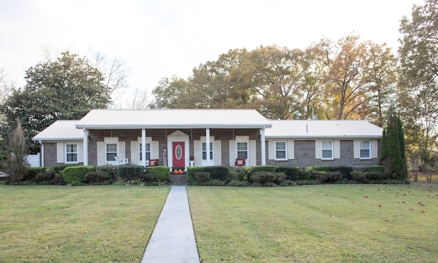 single story home with a front yard and covered porch