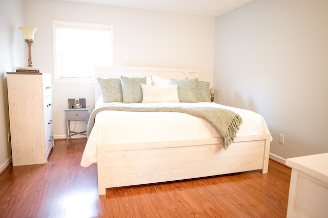 bedroom featuring wood-type flooring and a textured ceiling