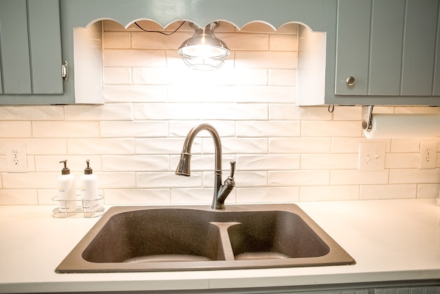 kitchen with backsplash, sink, and green cabinetry