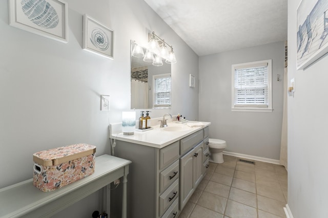 bathroom with a shower with curtain, vanity, tile patterned floors, and toilet