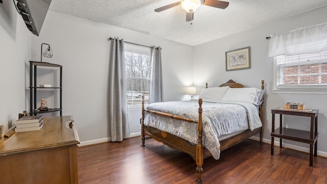 bedroom with ceiling fan, dark hardwood / wood-style flooring, and a textured ceiling