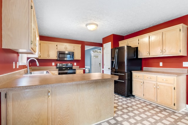 kitchen with appliances with stainless steel finishes, a textured ceiling, light brown cabinetry, sink, and kitchen peninsula