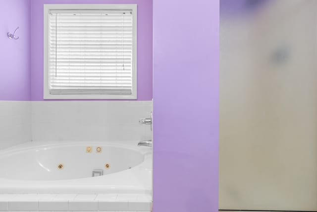 bathroom featuring a relaxing tiled tub