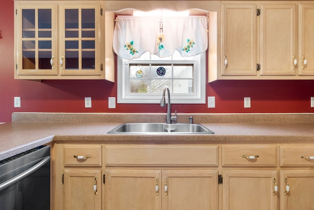 kitchen featuring light brown cabinetry, stainless steel dishwasher, and sink