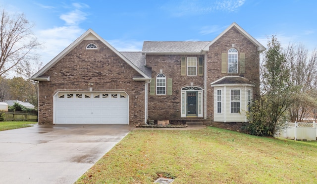 front facade with a front lawn and a garage