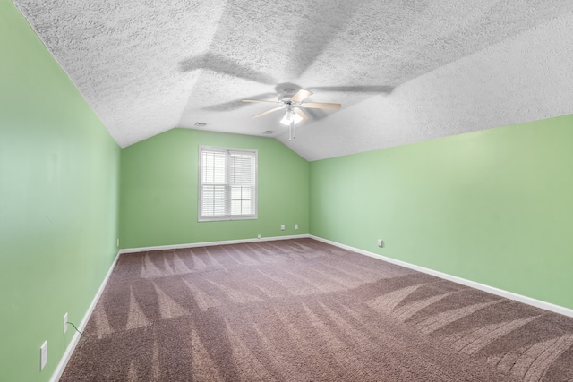 bonus room with lofted ceiling, a textured ceiling, carpet flooring, and ceiling fan