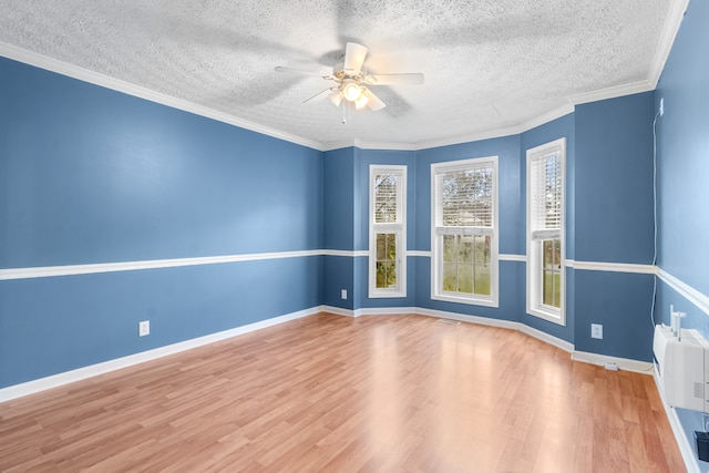 unfurnished room with hardwood / wood-style floors, ceiling fan, a textured ceiling, and ornamental molding