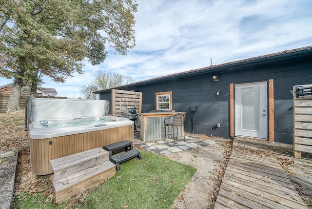 exterior space with a hot tub