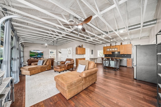 living room featuring dark wood-type flooring and ceiling fan