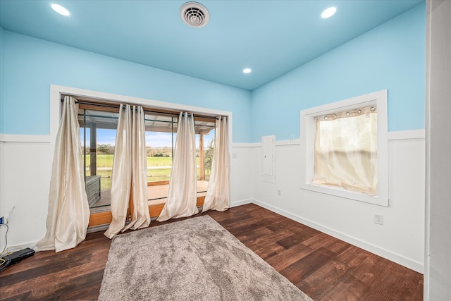 empty room with dark hardwood / wood-style flooring