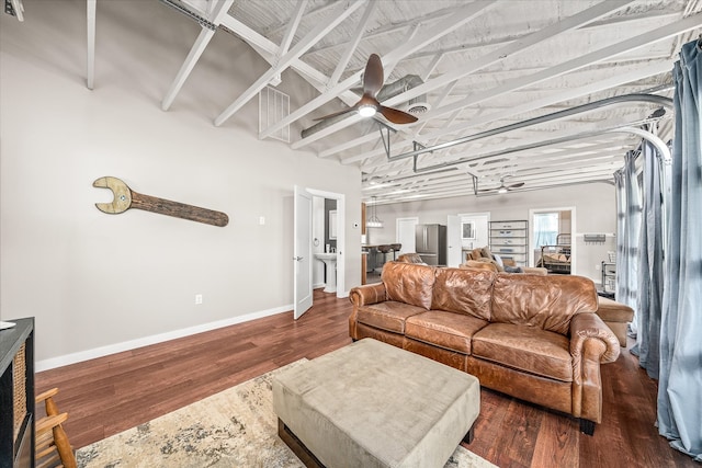 living room with dark hardwood / wood-style flooring and ceiling fan