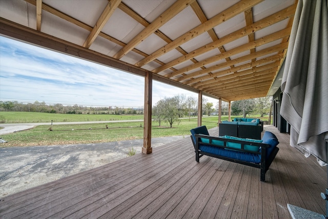 wooden terrace with a rural view and a yard