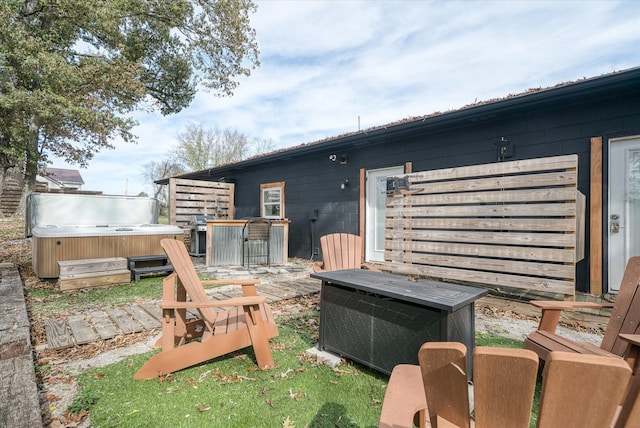 exterior space featuring a hot tub and a patio area