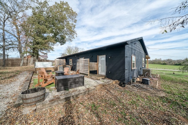 rear view of property with central AC unit