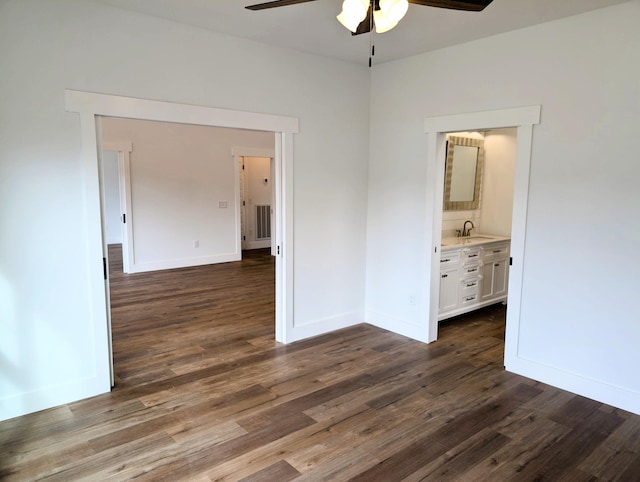 unfurnished room with ceiling fan, dark wood-type flooring, and sink