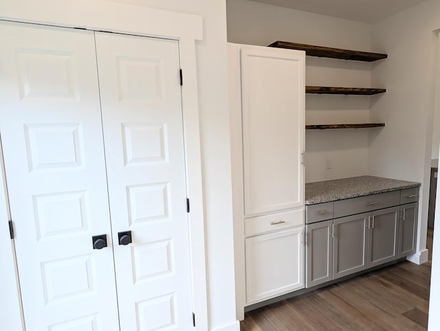 interior space with gray cabinetry and dark hardwood / wood-style flooring