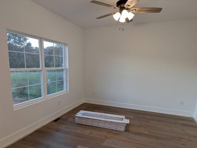 unfurnished room featuring ceiling fan and dark hardwood / wood-style flooring