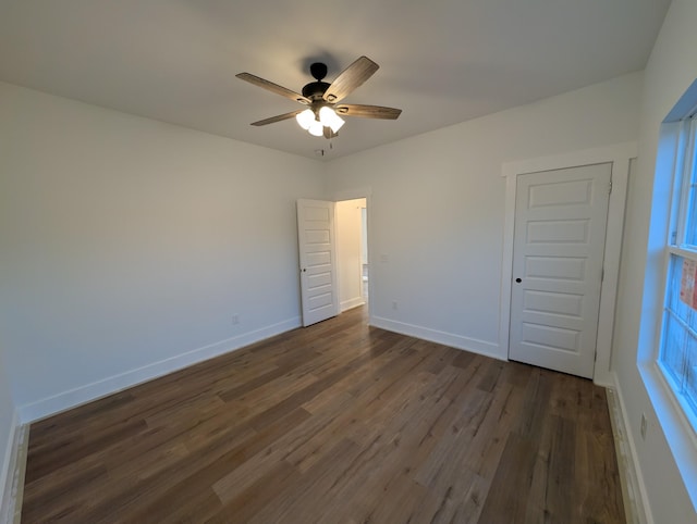 unfurnished bedroom featuring a closet, dark hardwood / wood-style floors, and ceiling fan