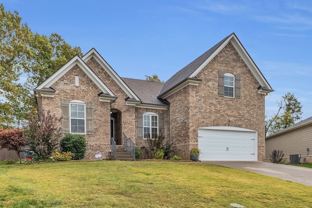 view of front facade with a garage, a front yard, and central AC