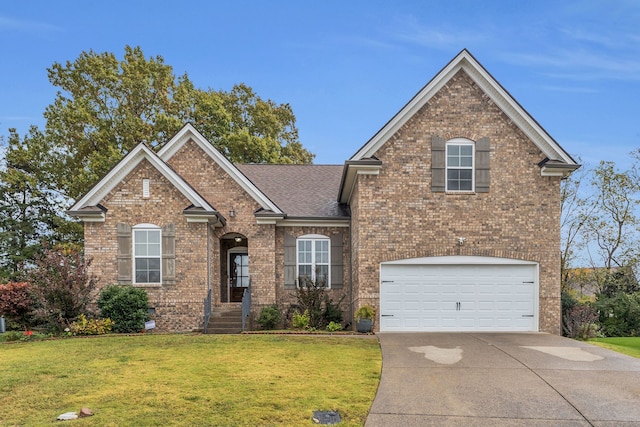 view of front of home with a garage and a front lawn