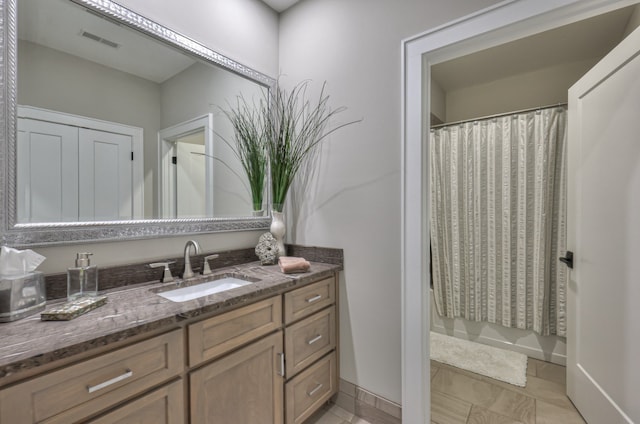 bathroom featuring vanity and a shower with shower curtain