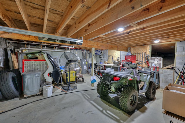 basement with water heater and a workshop area