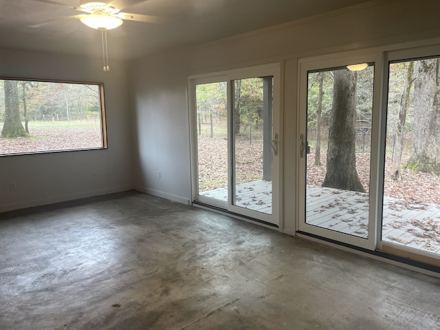 interior space featuring concrete flooring and ceiling fan