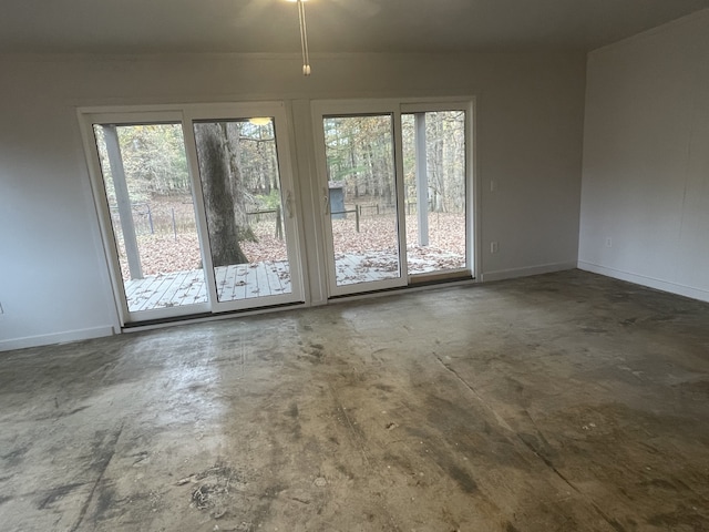 unfurnished room with concrete floors