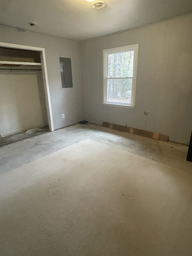 unfurnished bedroom with a closet and electric panel