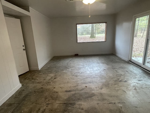 unfurnished room featuring ceiling fan and a healthy amount of sunlight