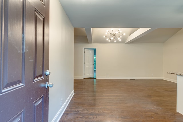 entrance foyer with dark hardwood / wood-style floors and an inviting chandelier