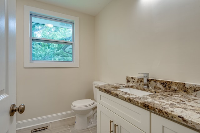 bathroom with vanity, hardwood / wood-style flooring, and toilet