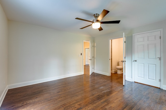 unfurnished bedroom featuring ensuite bath, ceiling fan, and dark hardwood / wood-style floors