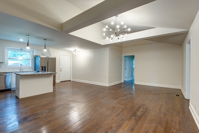 unfurnished living room featuring dark hardwood / wood-style flooring, a chandelier, sink, and vaulted ceiling with beams