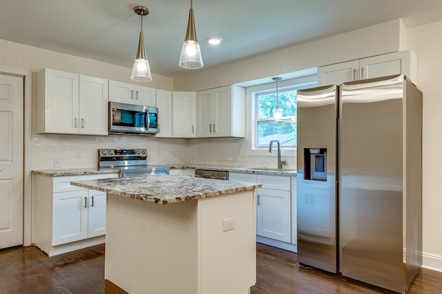 kitchen featuring white cabinetry, stainless steel appliances, a kitchen island, and dark hardwood / wood-style flooring