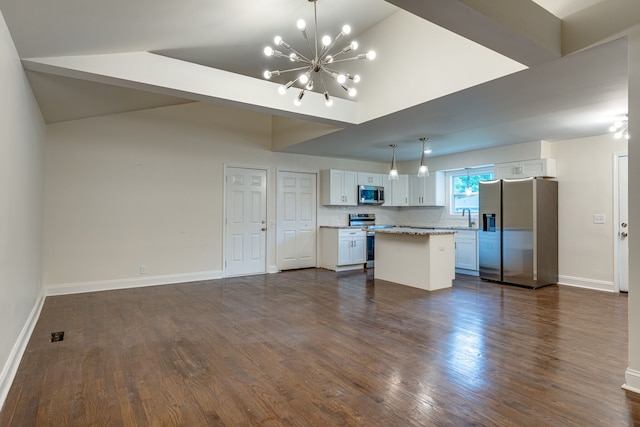 kitchen featuring stainless steel appliances, white cabinets, dark wood-type flooring, and a center island