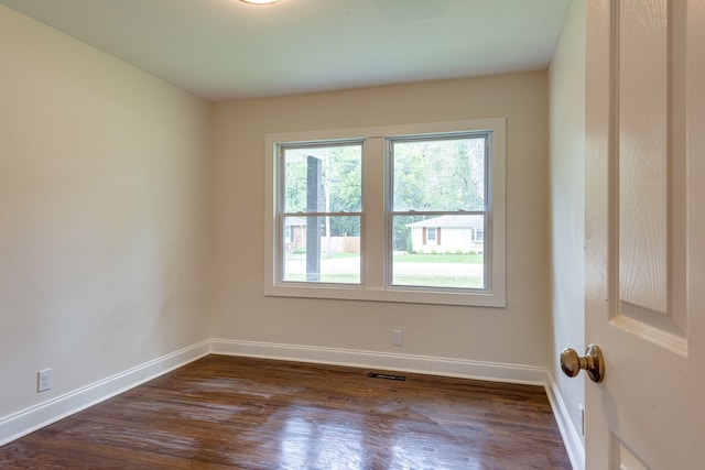 empty room with dark wood-type flooring