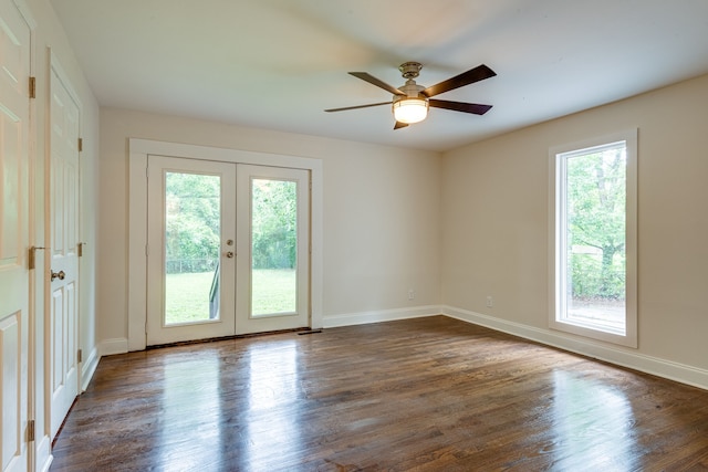 unfurnished room with ceiling fan, french doors, a healthy amount of sunlight, and dark hardwood / wood-style floors