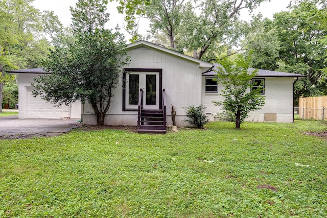 view of front of property with a garage and a front yard