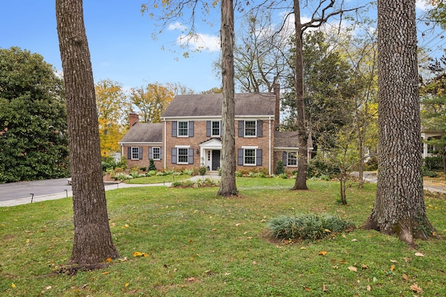 colonial inspired home with a front yard