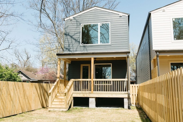 view of front of home featuring a fenced backyard and a deck